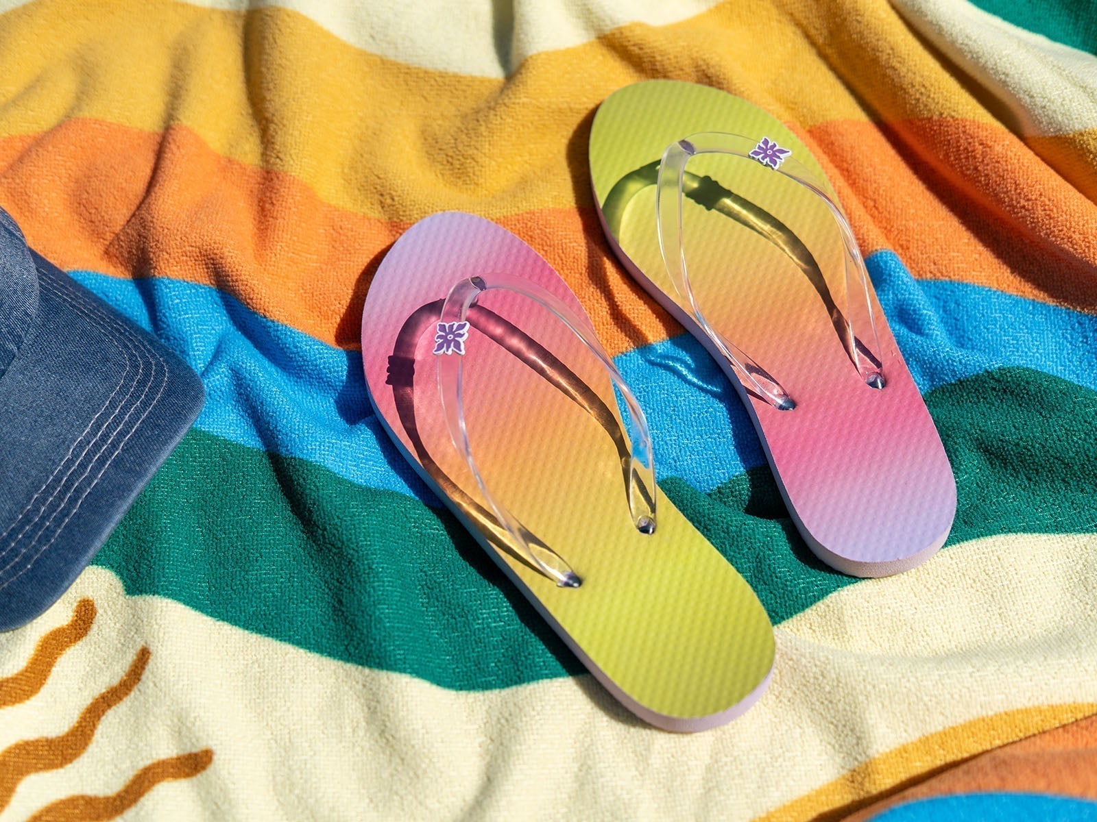 Packs beach towel and flip-flops