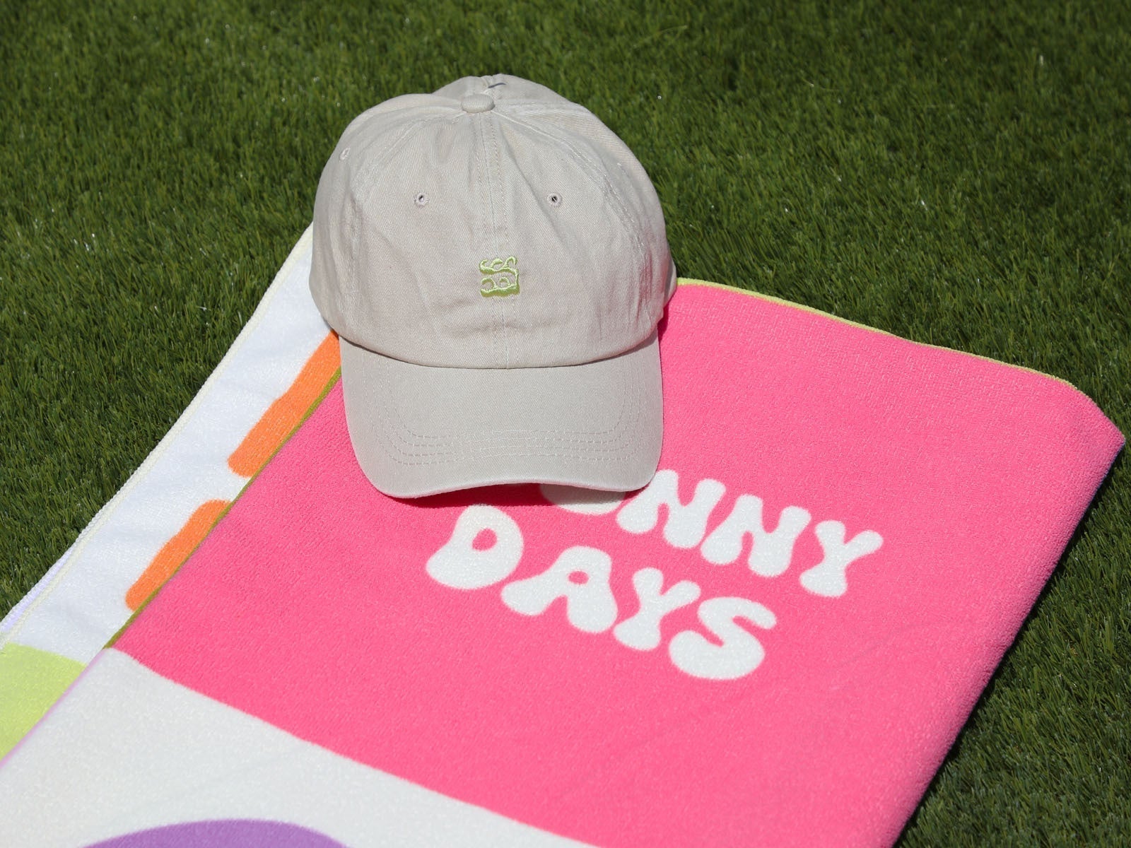 Packs beach towel and cap